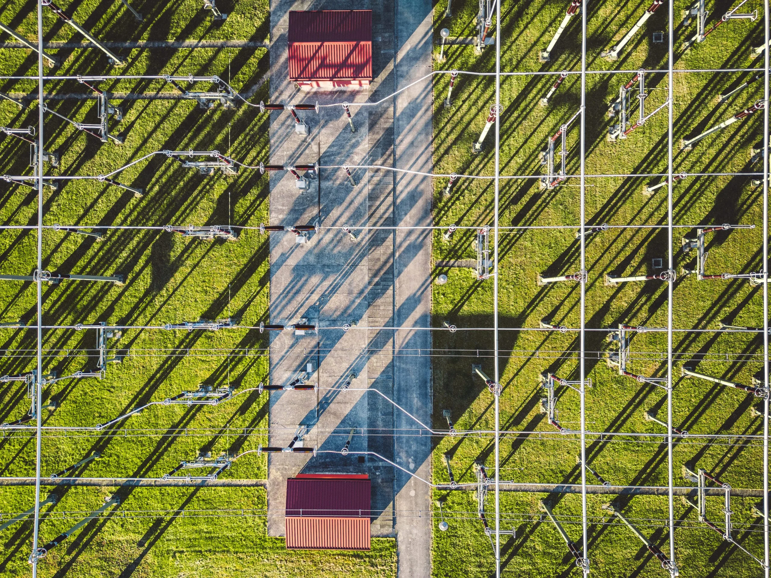 Directly above electrical substation with electrical wires spread around the power station